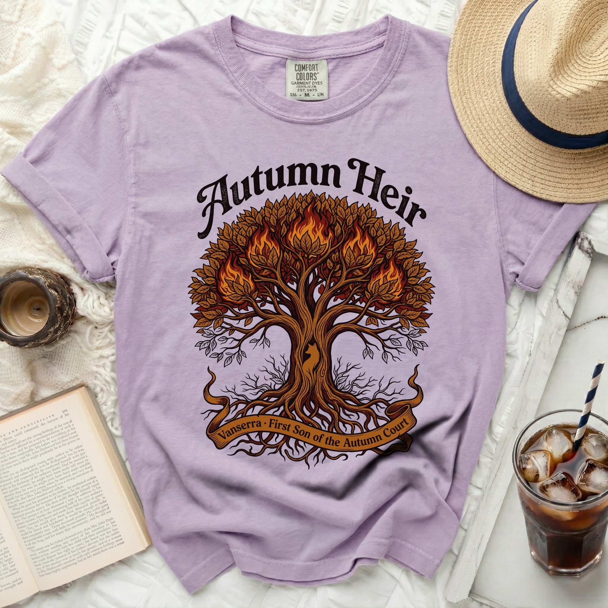 Purple t-shirt with "Autumn Heir" and a fiery tree design.