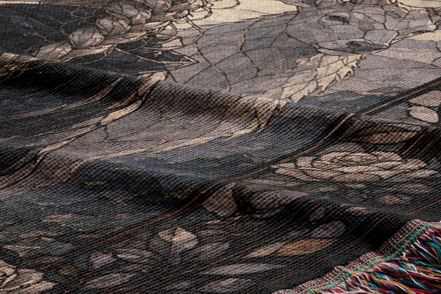a close-up view of a textured fabric with a floral pattern. The fabric appears to be a woven or knitted material, with a dark background and a lighter, more intricate floral design in the center.