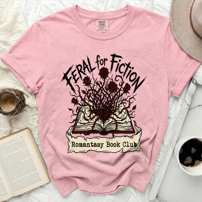 Pink t-shirt with "Feral for Fiction Romantasy Book Club" text and a thorny rose design.
