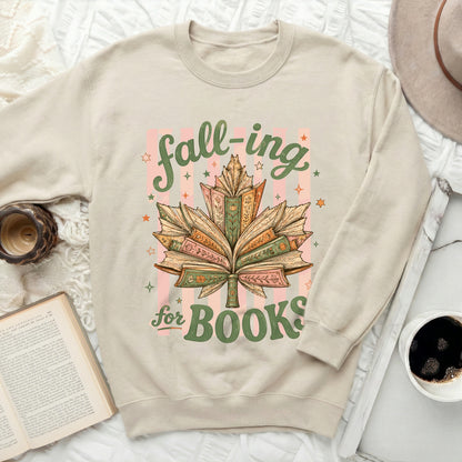 Cream sweatshirt with "fall-ing for BOOKS" text and book leaf graphic.