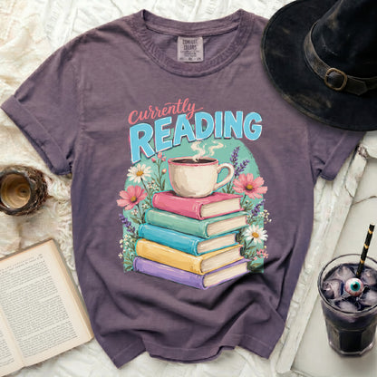 Purple t-shirt with "Currently Reading" text and stack of books.