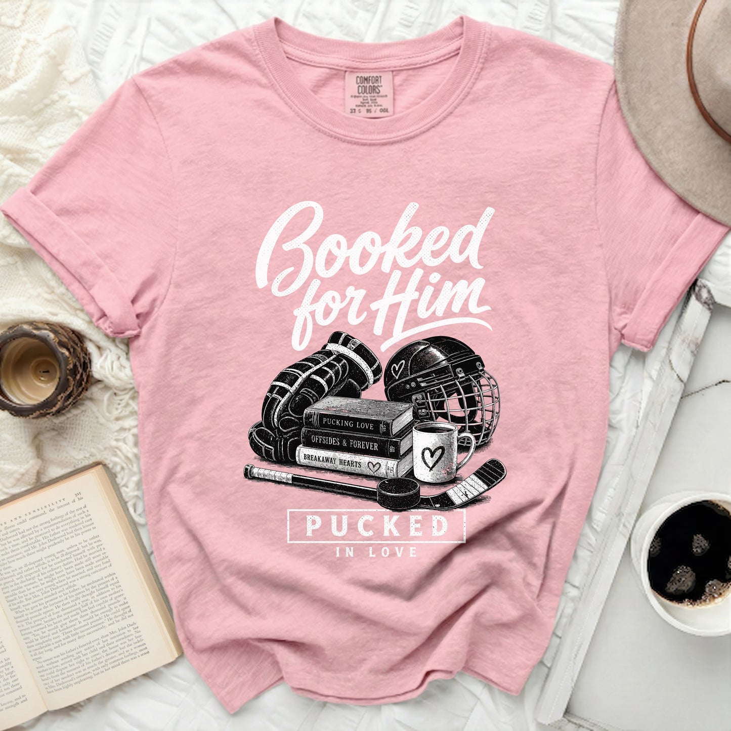 Pink t-shirt with "Booked for Him" and hockey graphics.