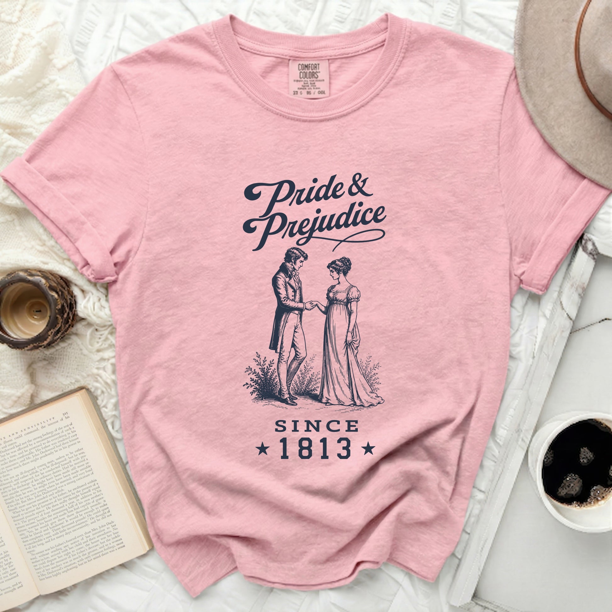 Pink t-shirt with "Pride & Prejudice Since 1813" and illustration.