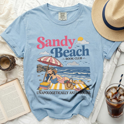 Sandy Beach Book Club graphic t-shirt with a woman reading on the beach.