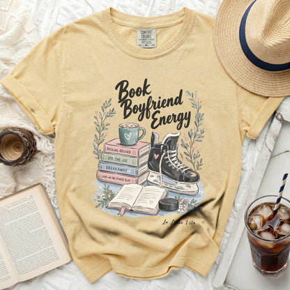 Yellow t-shirt with "Book Boyfriend Energy" text and hockey graphics.