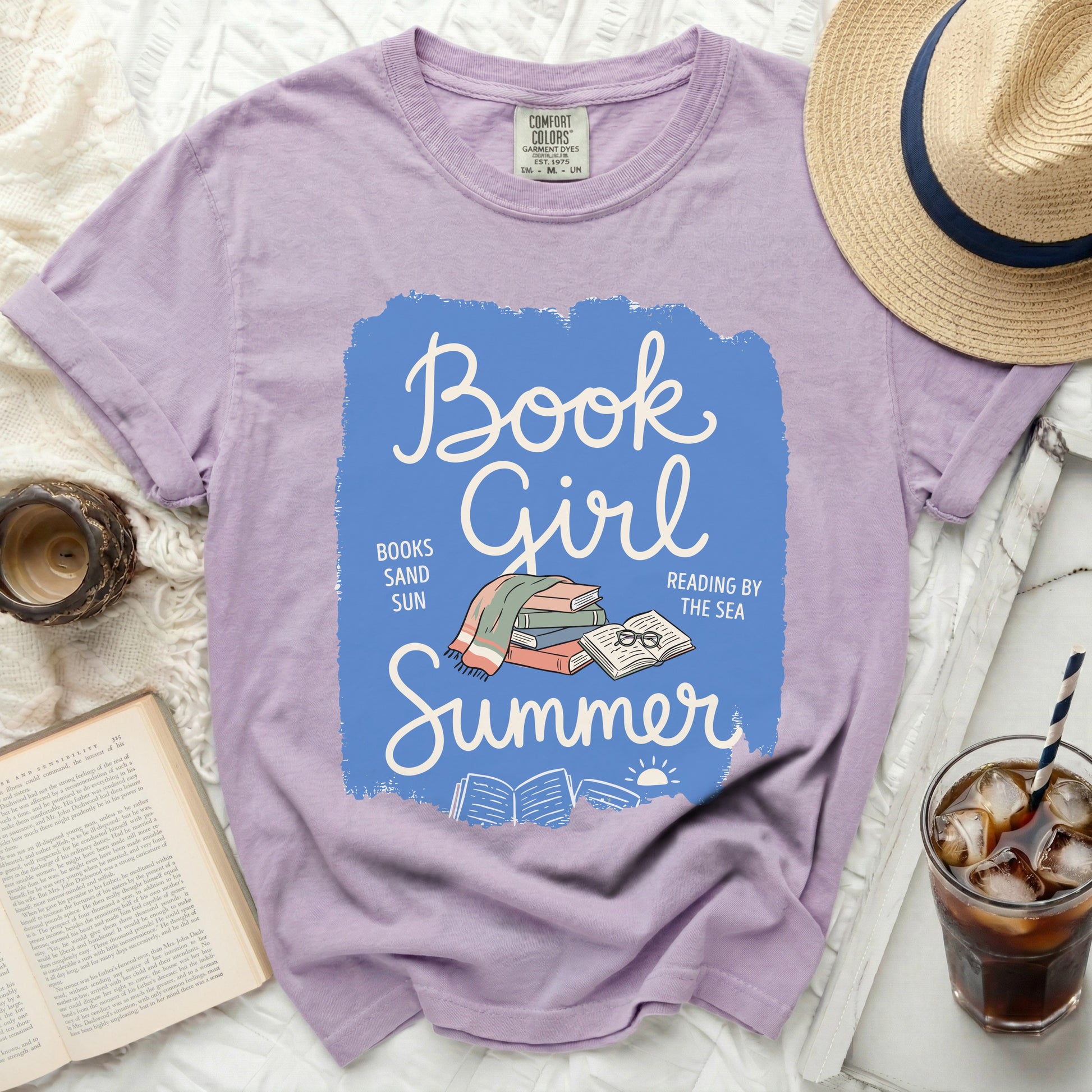 Purple t-shirt with "Book Girl Summer" graphic and open book.
