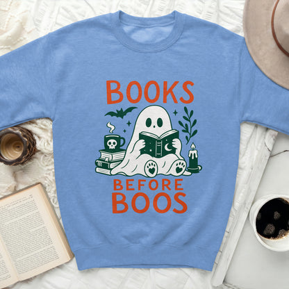 Ghost reading books on sweatshirt with text "BOOKS BEFORE BOOS".