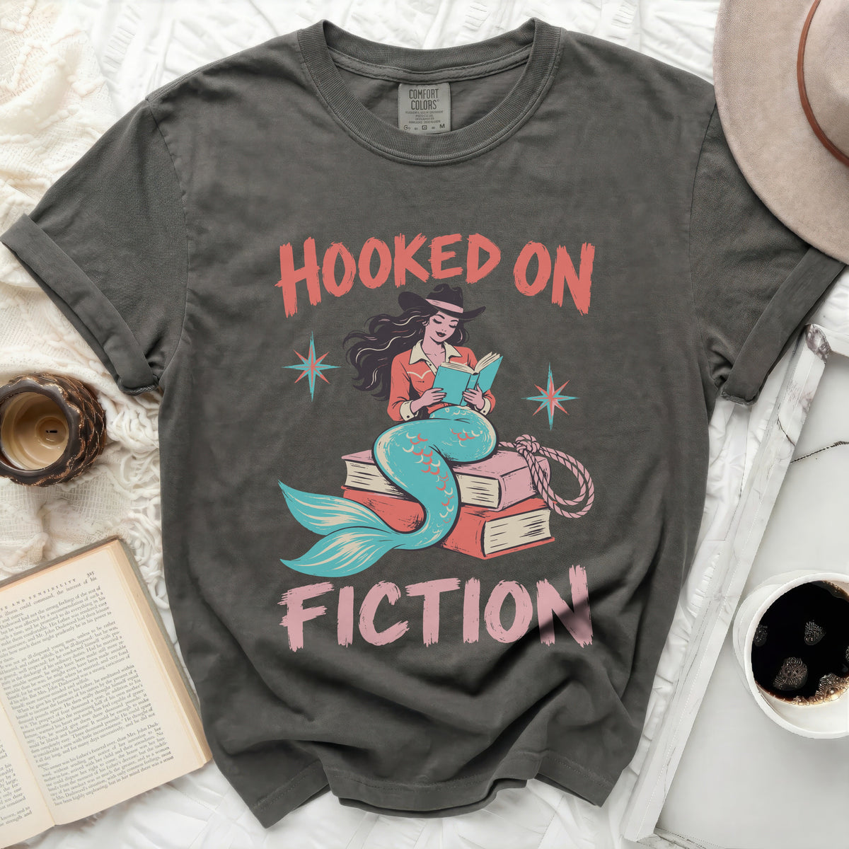Gray t-shirt with "Hooked on Fiction" text and mermaid reading books.