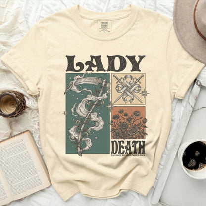 Cream t-shirt with "Lady Death" graphic featuring scythe, swords, and flowers.