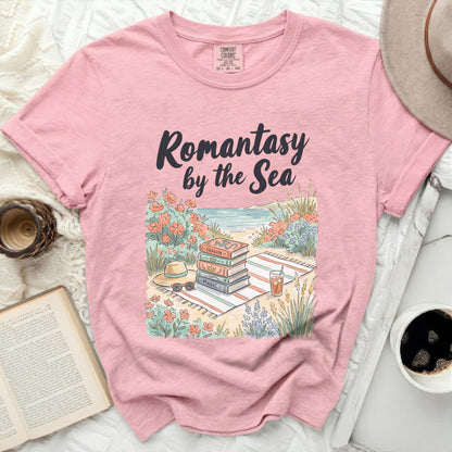 Pink t-shirt with "Romantasy by the Sea" text and stacked books.