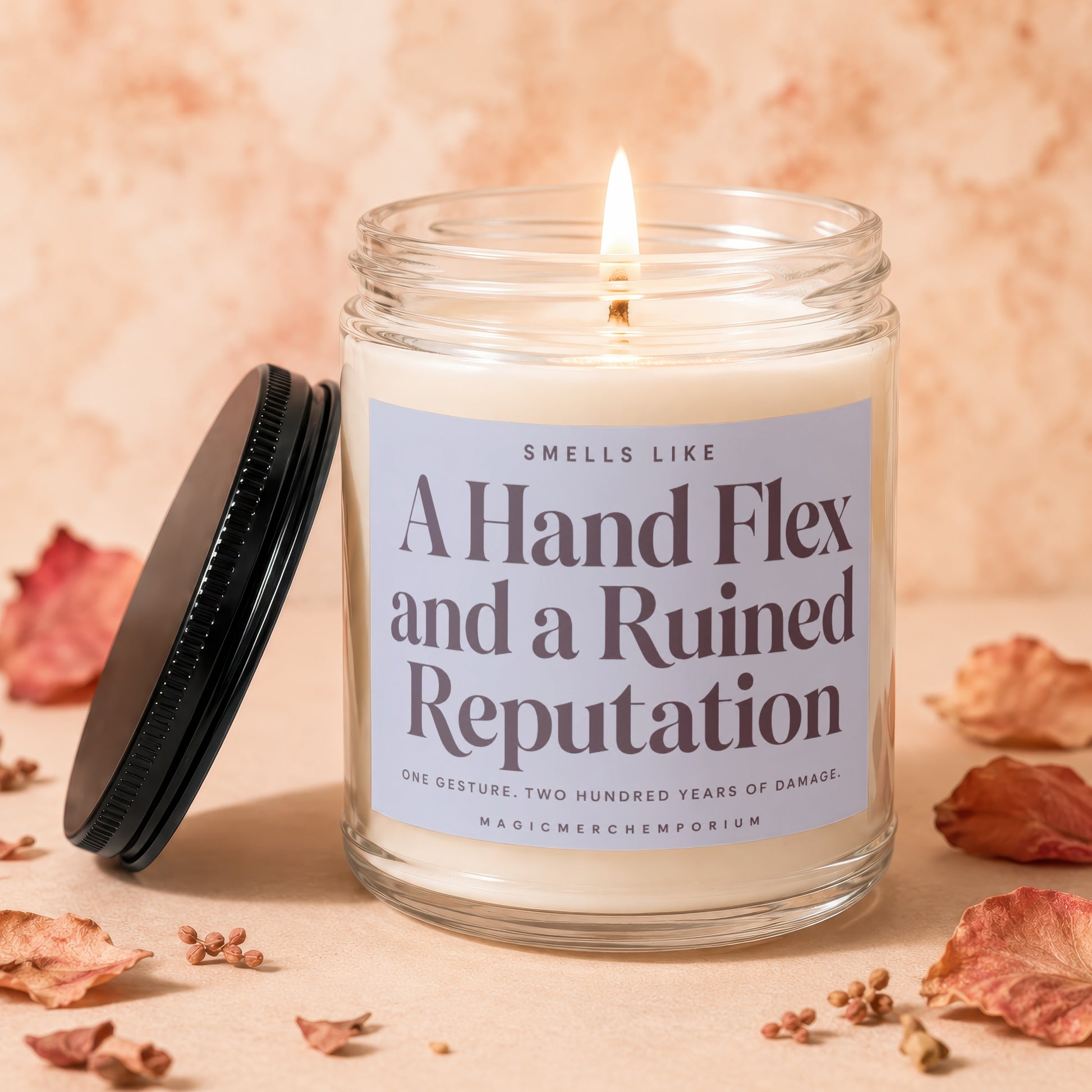 Candle with label "A Hand Flex and a Ruined Reputation" and dried leaves.