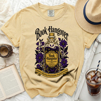 Yellow t-shirt with "Book Hangover" text and potion bottle graphic.