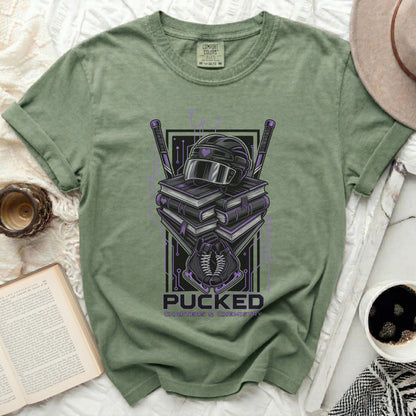 Green t-shirt with hockey helmet, books, and crossed hockey sticks.