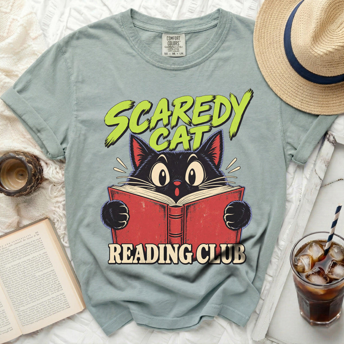 "Scaredy Cat Reading Club" graphic on a light teal t-shirt.
