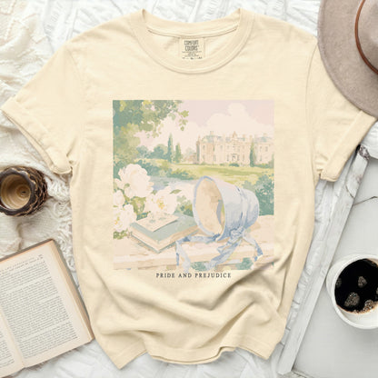 Cream t-shirt with "Pride and Prejudice" print of a manor and garden scene.