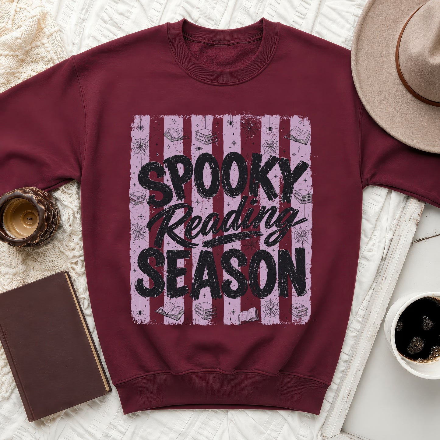 Maroon sweatshirt with graphic "Spooky Reading Season" and Halloween imagery.