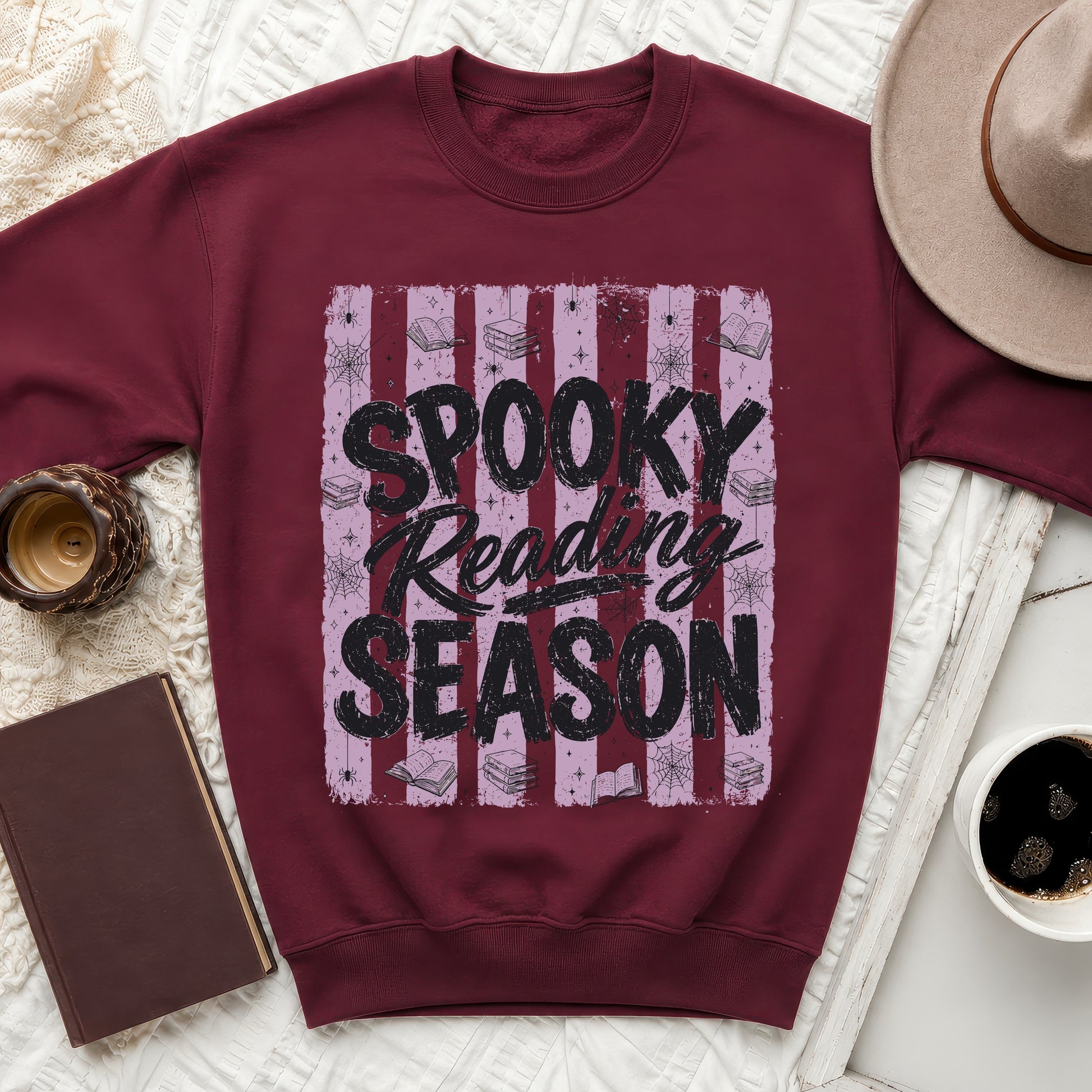 Maroon sweatshirt with graphic "Spooky Reading Season" and Halloween imagery.