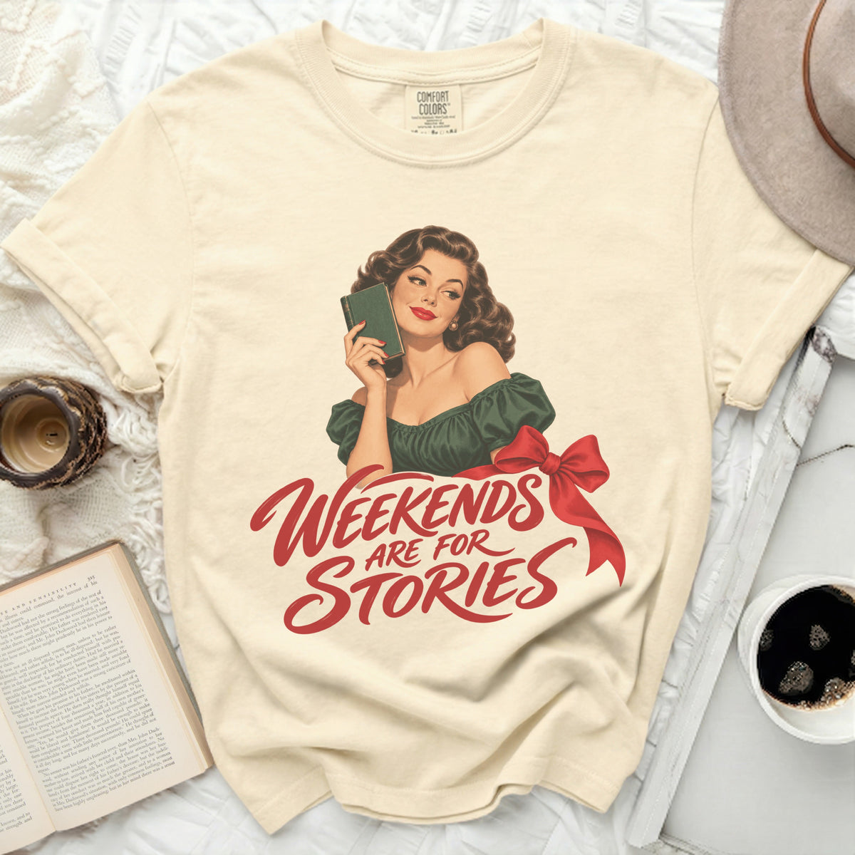 Cream t-shirt with graphic of woman holding book and text "Weekends Are For Stories".