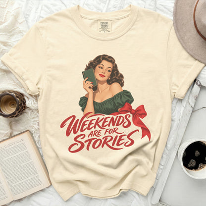 Cream t-shirt with graphic of woman holding book and text "Weekends Are For Stories".