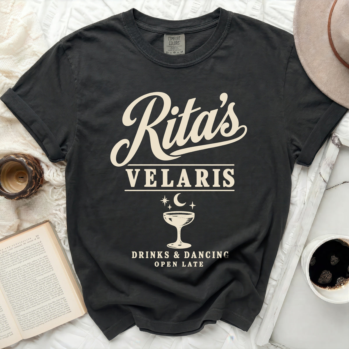 Dark t-shirt with "Rita's Velaris, Drinks & Dancing, Open Late" text.