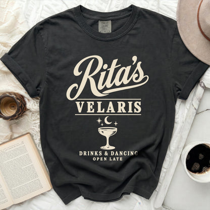 Dark t-shirt with "Rita's Velaris, Drinks & Dancing, Open Late" text.