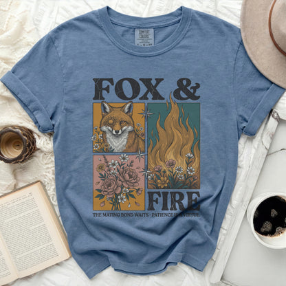 Blue t-shirt with "Fox & Fire" graphic, featuring a fox, flames, and flowers.