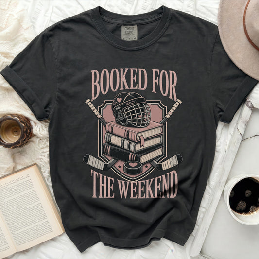 Black t-shirt with "Booked for the Weekend" text and hockey gear graphic.