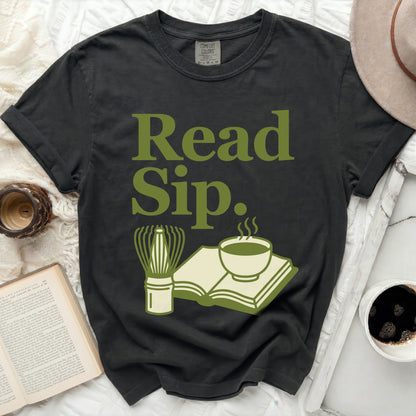 Dark t-shirt with "Read Sip." graphic and drinking/reading icons.