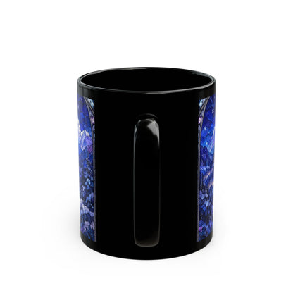 A black ceramic mug featuring a blue stained-glass mountain landscape design flanking the handle.
