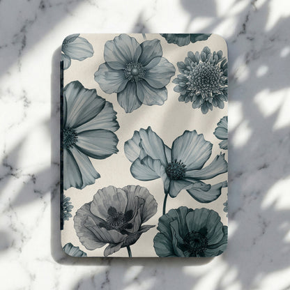 Notebook with a blue floral pattern on a marbled background with shadows.