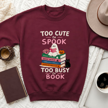 Maroon sweatshirt with "Too Cute to Spook" and "Too Busy to Book" text.