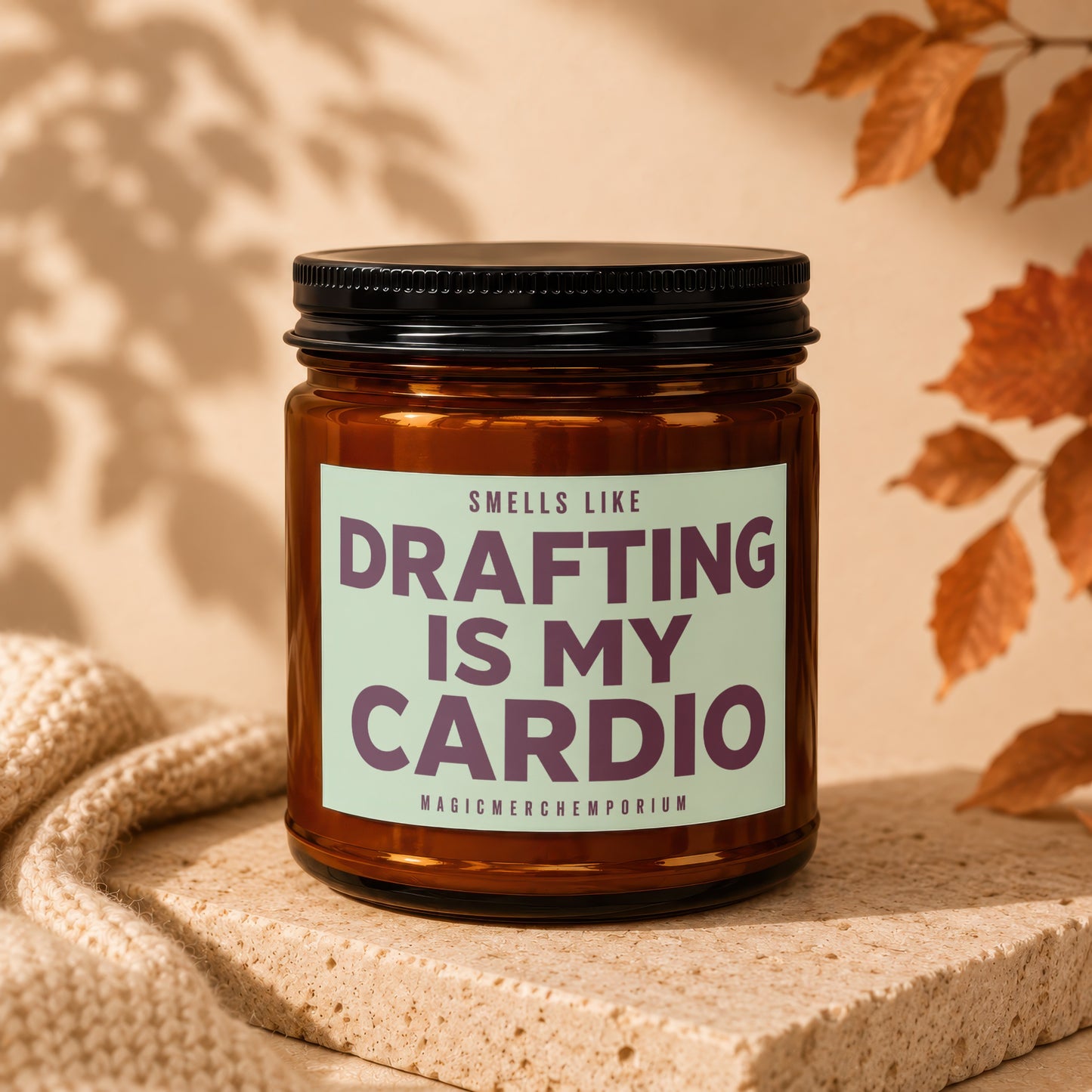 Amber candle with label text "Drafting is My Cardio" and "MagicMerchEmporium".