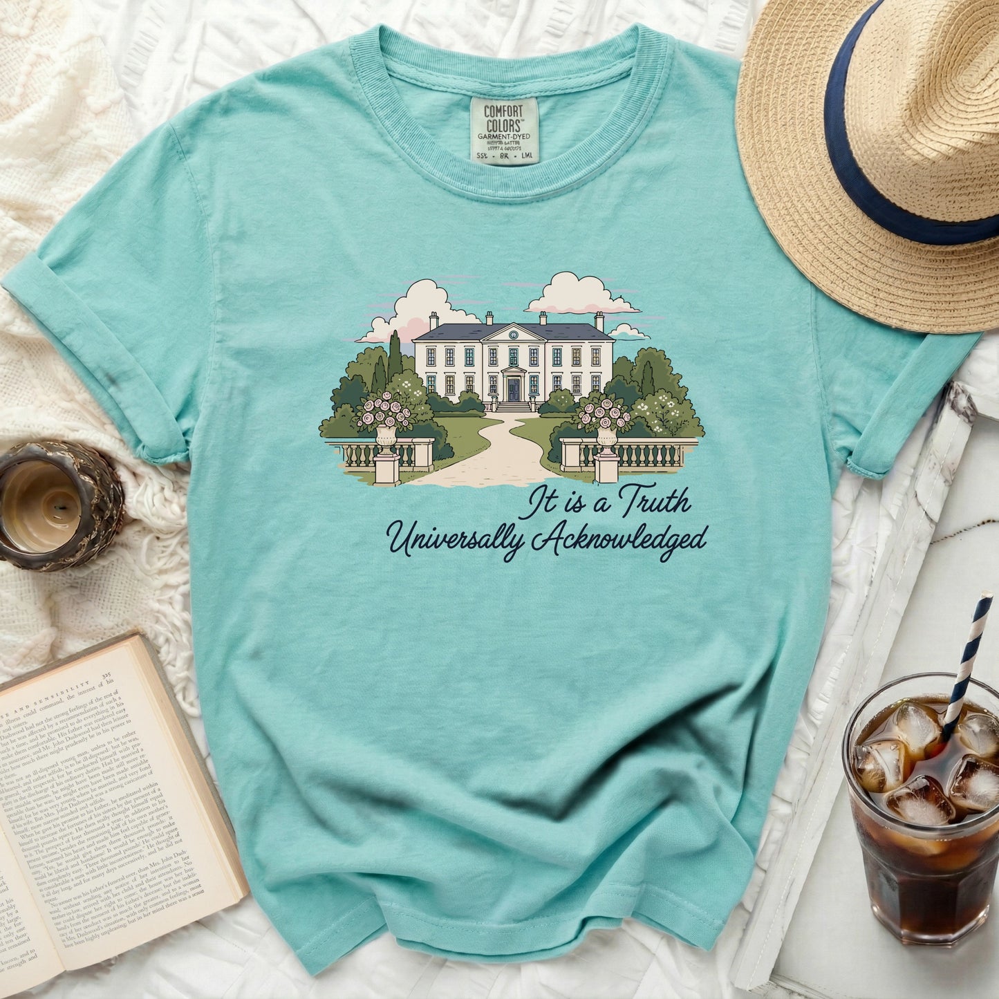 Aqua t-shirt with illustration of a white mansion and text.