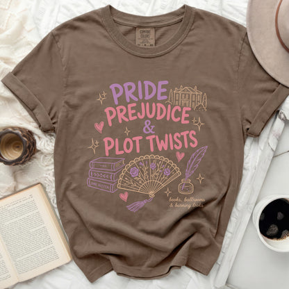 Brown t-shirt with "Pride Prejudice & Plot Twists" text, fan, books, and quill.