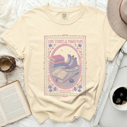 Cream t-shirt with "Love Stories & Power Plays" text and ice skates.