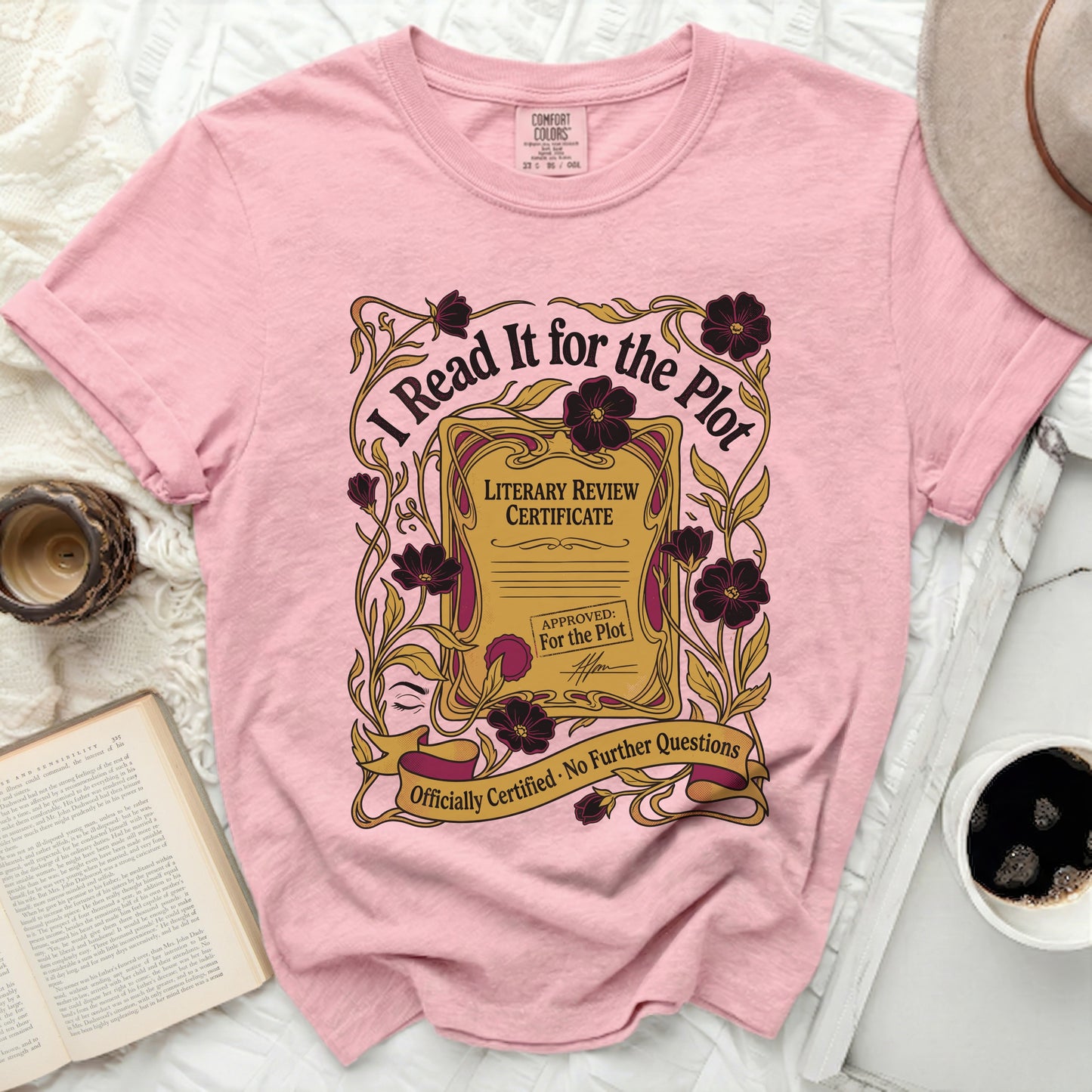 Pink t-shirt with "I Read It for the Plot" text and literary certificate design.