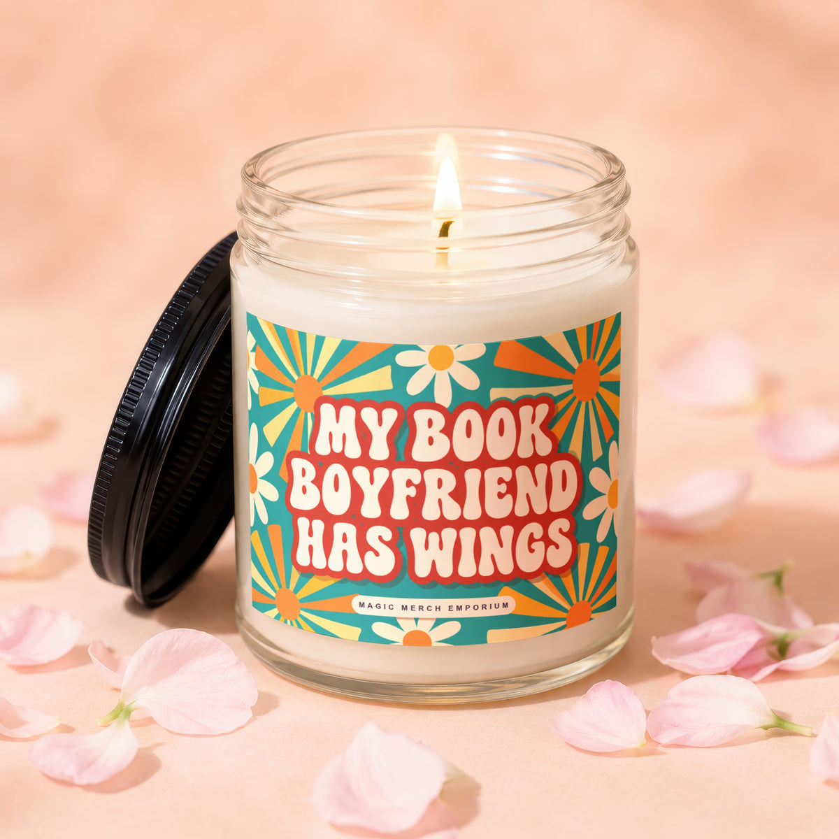 Candle with text "My Book Boyfriend Has Wings" and a retro floral design.