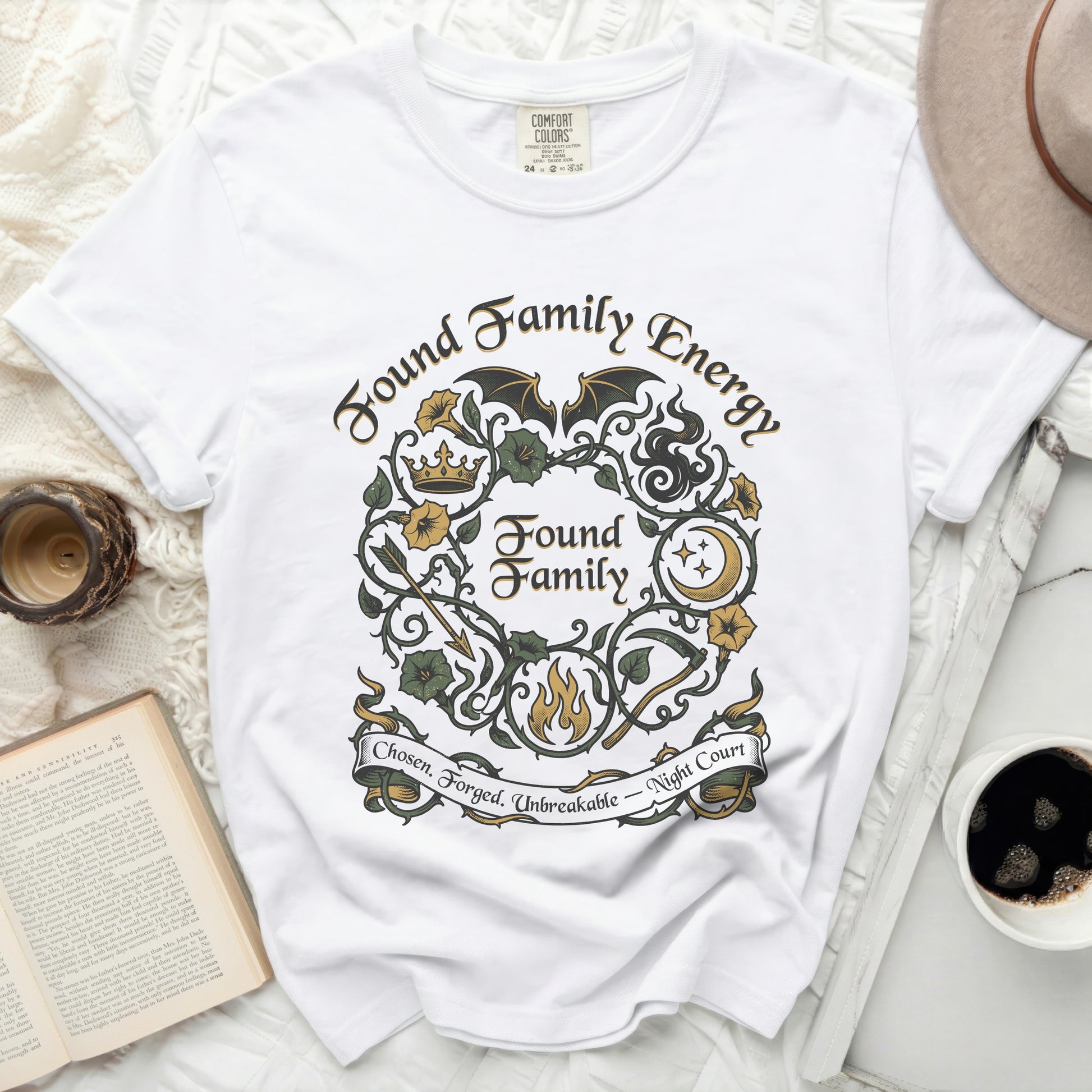 White t-shirt with "Found Family Energy" and floral wreath design.