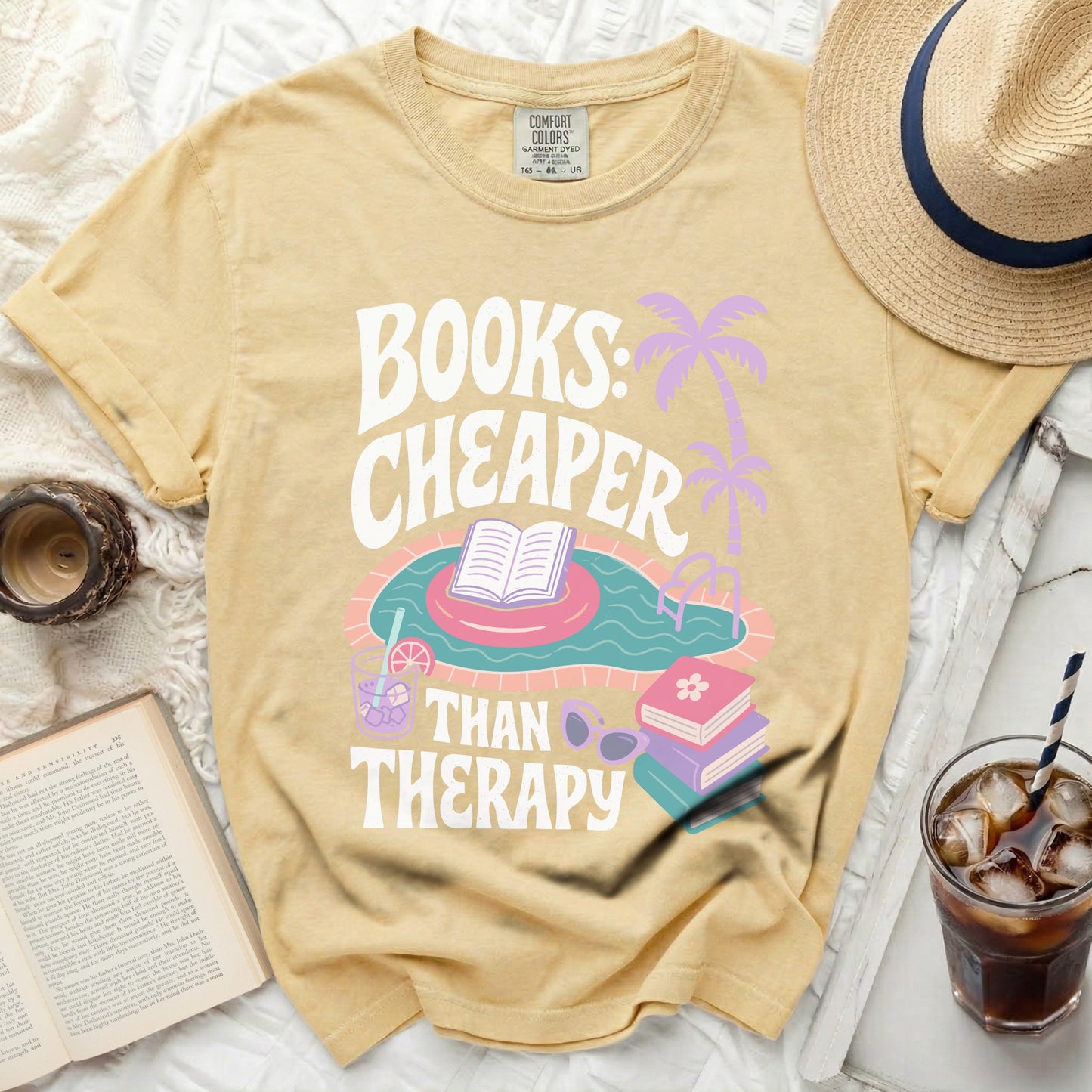Yellow t-shirt with "Books: Cheaper Than Therapy" graphic featuring a pool float.