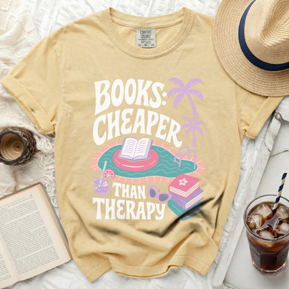 Yellow t-shirt with "Books: Cheaper Than Therapy" graphic featuring a pool float.