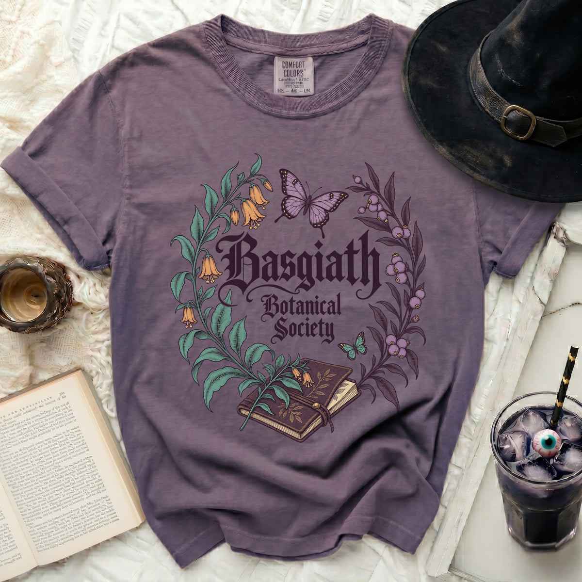 Purple t-shirt with "Basgiath Botanical Society" text and floral design.