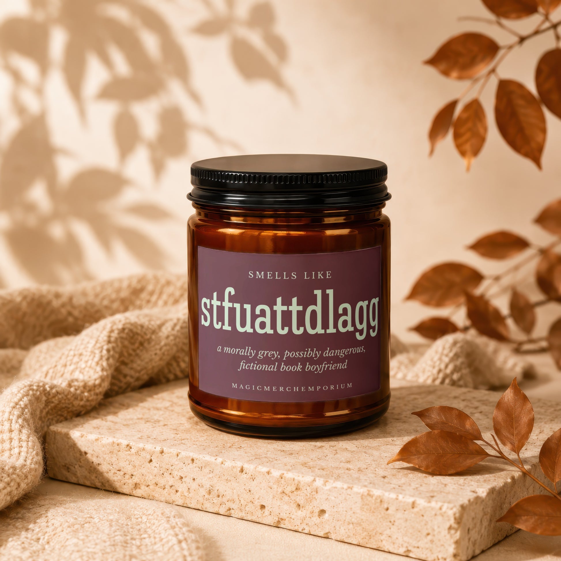 Amber candle in a brown jar with a purple label: Smells Like stfuattdlagg
