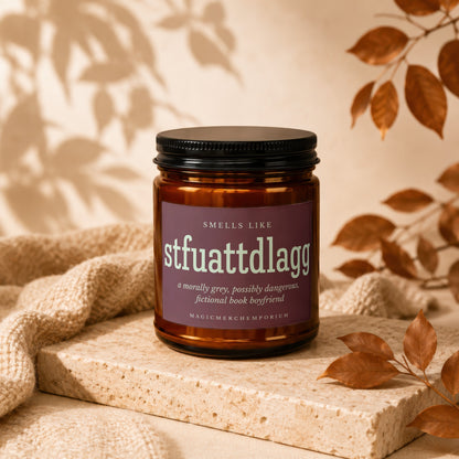 Amber candle in a brown jar with a purple label: Smells Like stfuattdlagg