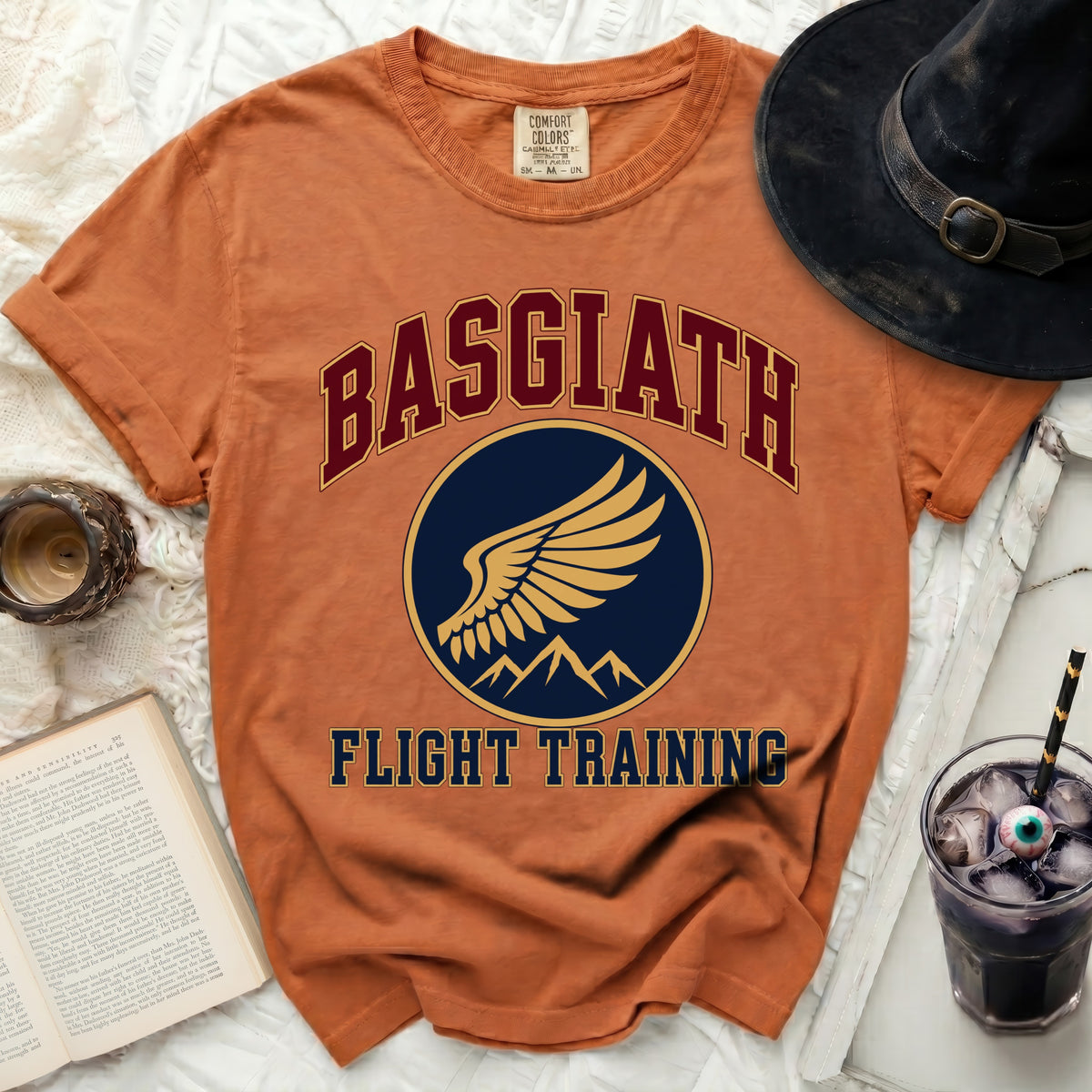 Orange t-shirt with "Basgiath Flight Training" text and winged emblem.