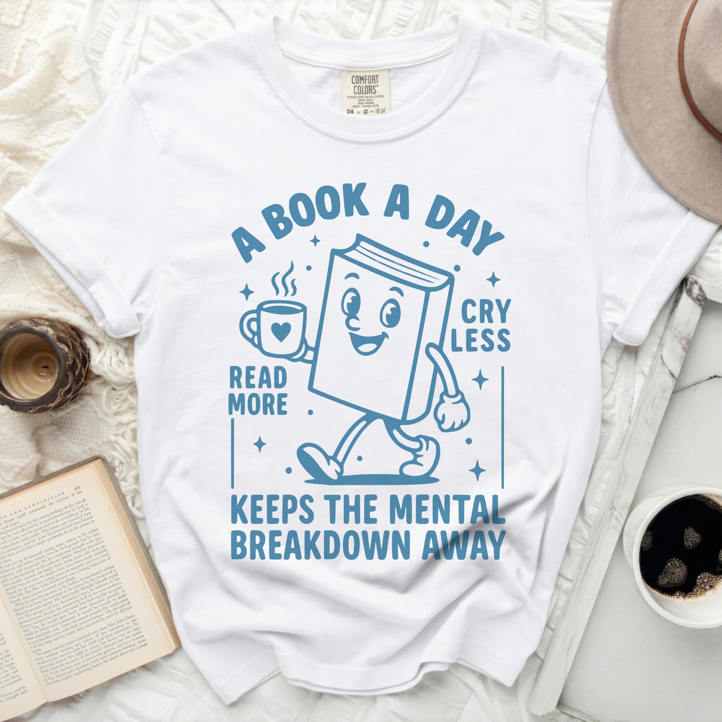 T-shirt with cartoon book reading "A book a day reads more, cry less, keeps the mental breakdown away."