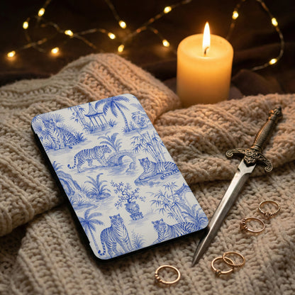 Phone case with blue and white tiger toile pattern rests on knitted fabric.