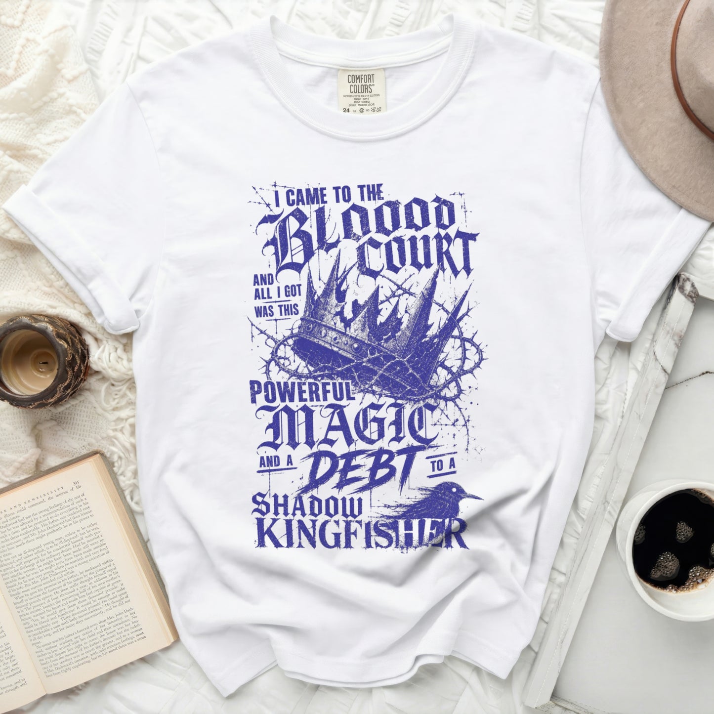 White t-shirt with "The Blood Court" text, crown, and bird graphic.