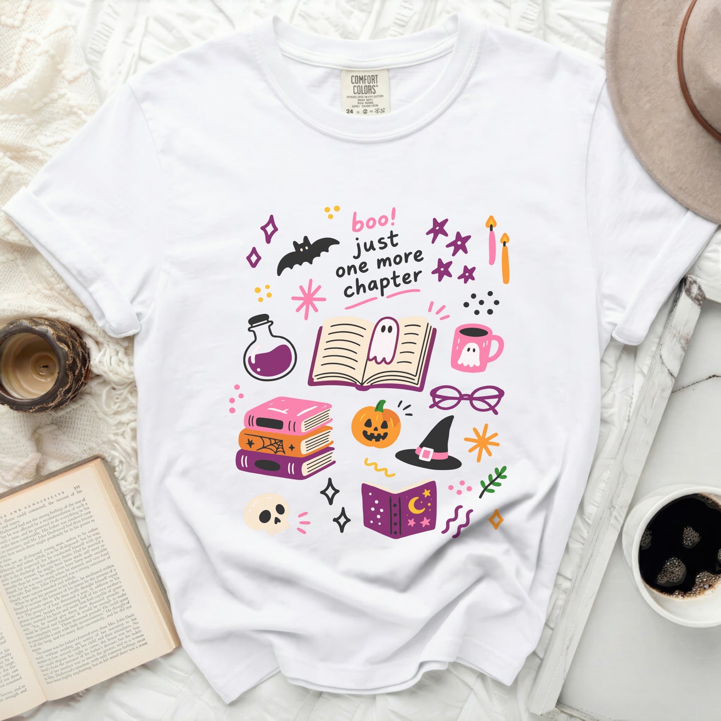 White t-shirt with "boo! just one more chapter" and Halloween illustrations.