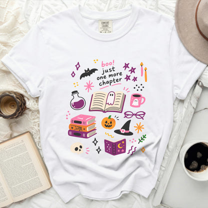 White t-shirt with "boo! just one more chapter" and Halloween illustrations.