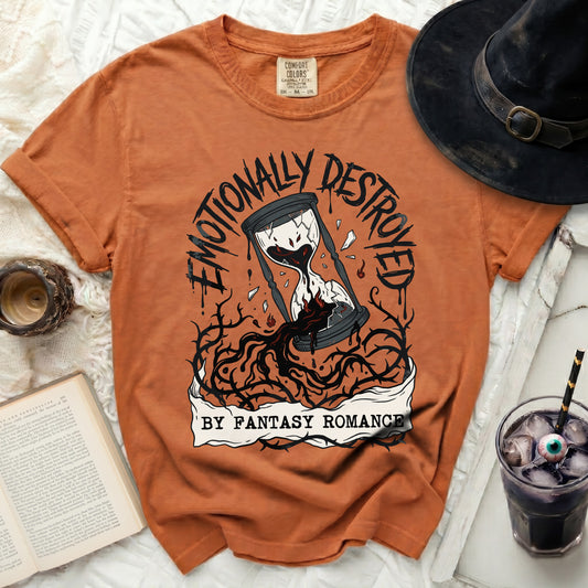 Orange t-shirt with "Emotionally Destroyed by Fantasy Romance" hourglass graphic.